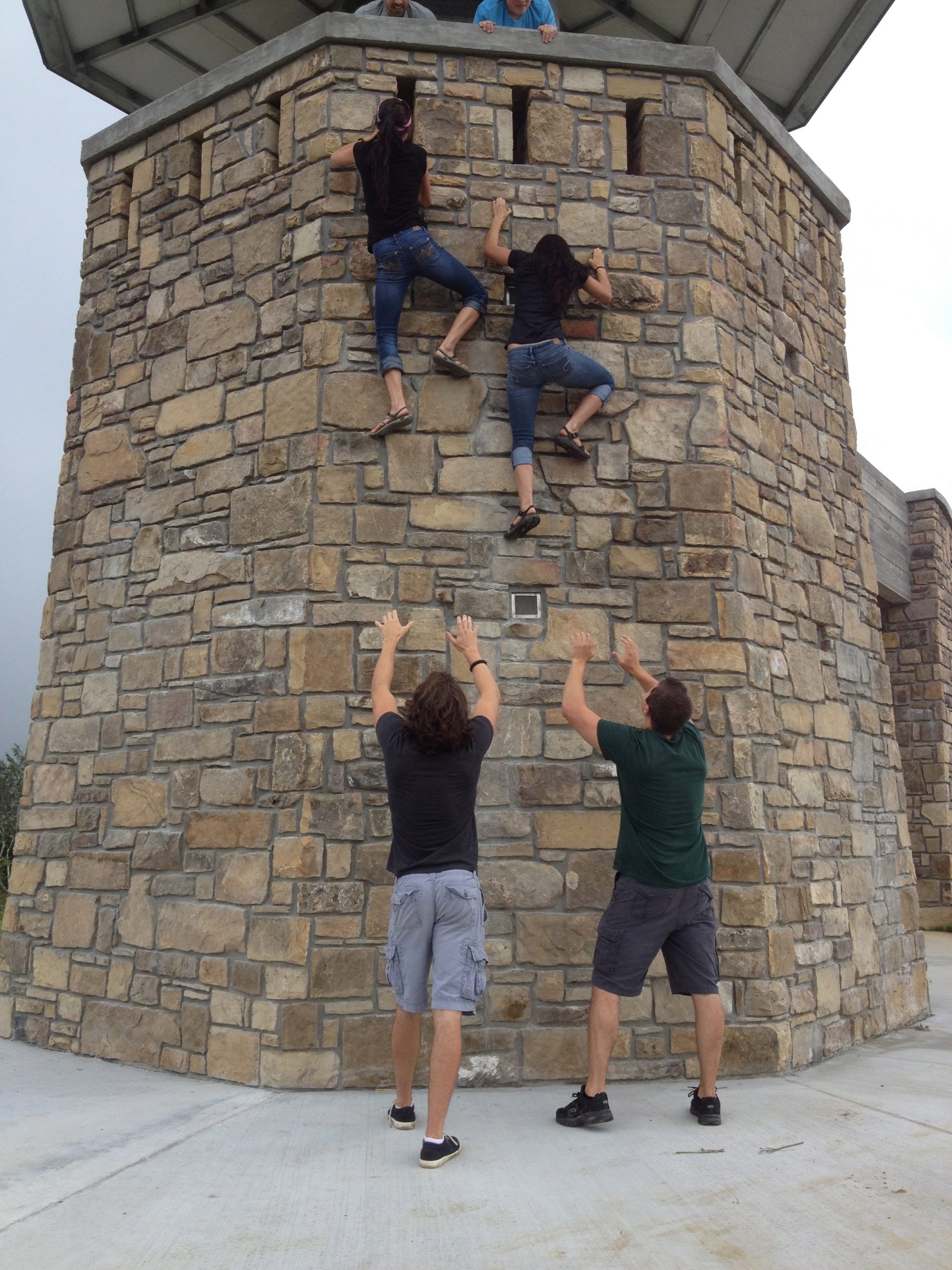Us girls free climbing the tower while the guys spot us.
