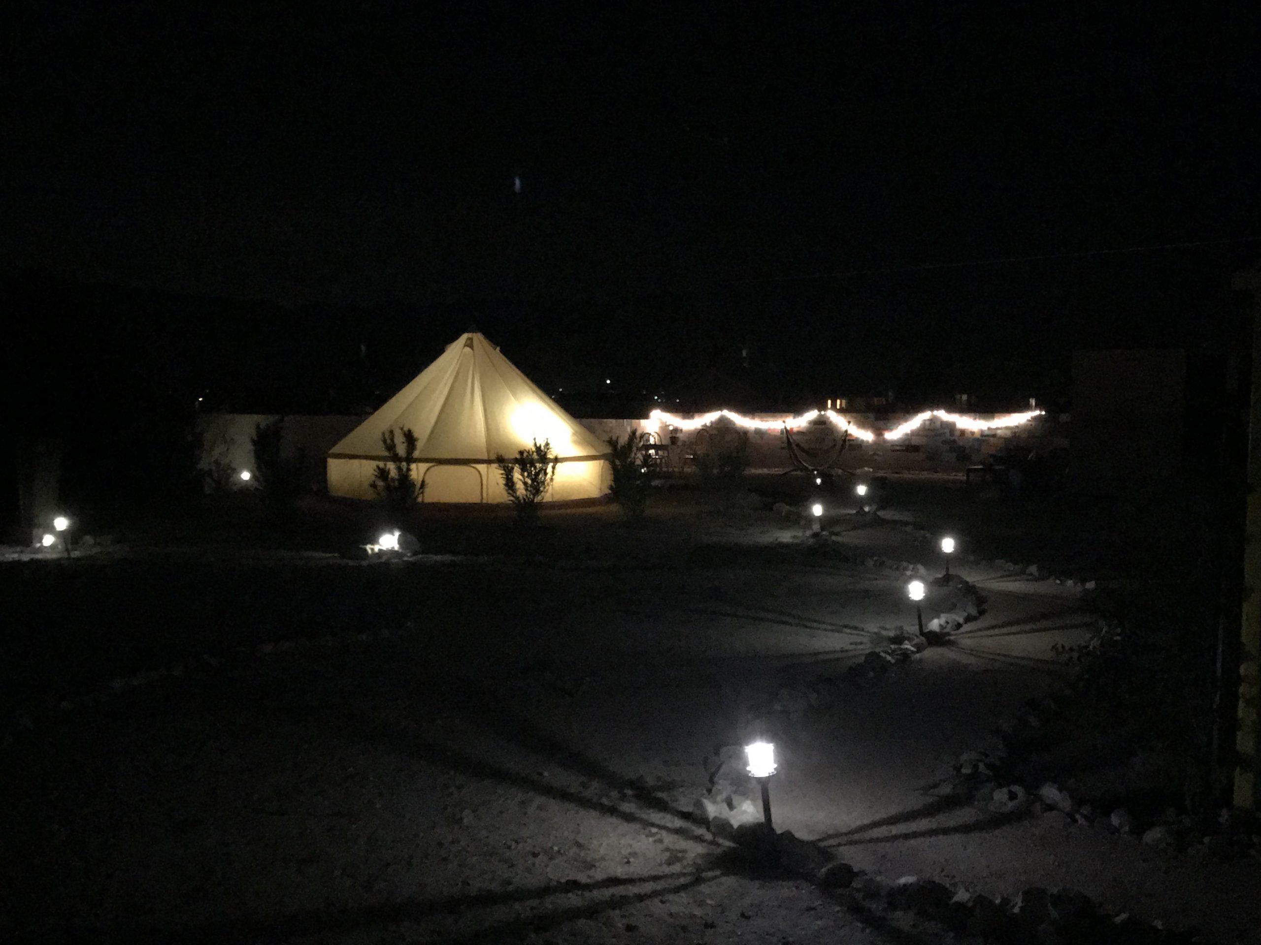 The other yurt on the property lit up at night